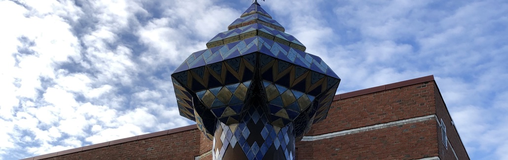 Høj stålsøjle med keramikudsmykning